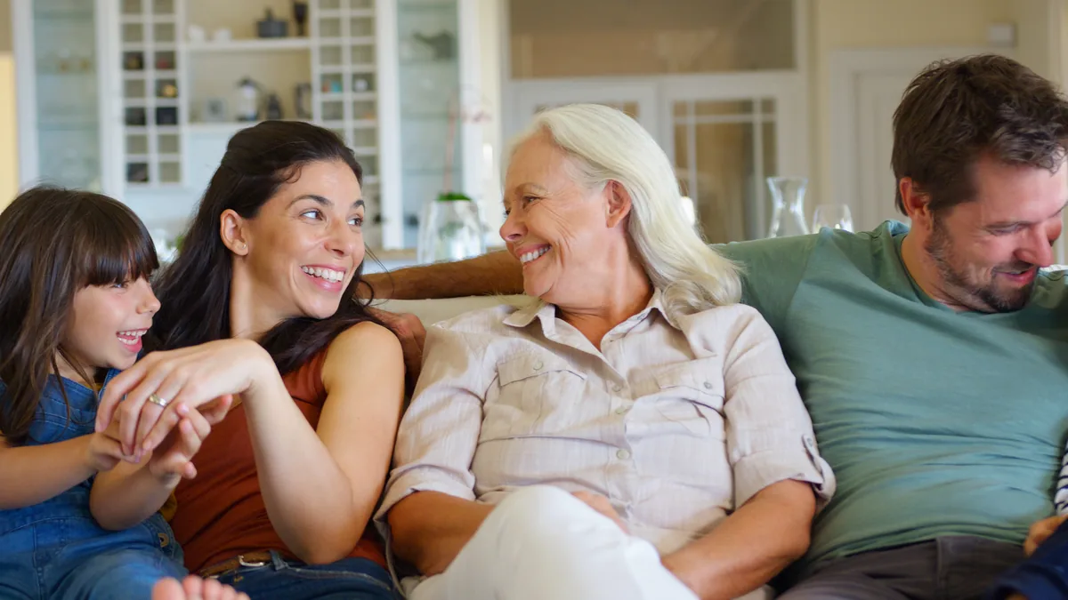 Three generations of a family relaxing together on a couch